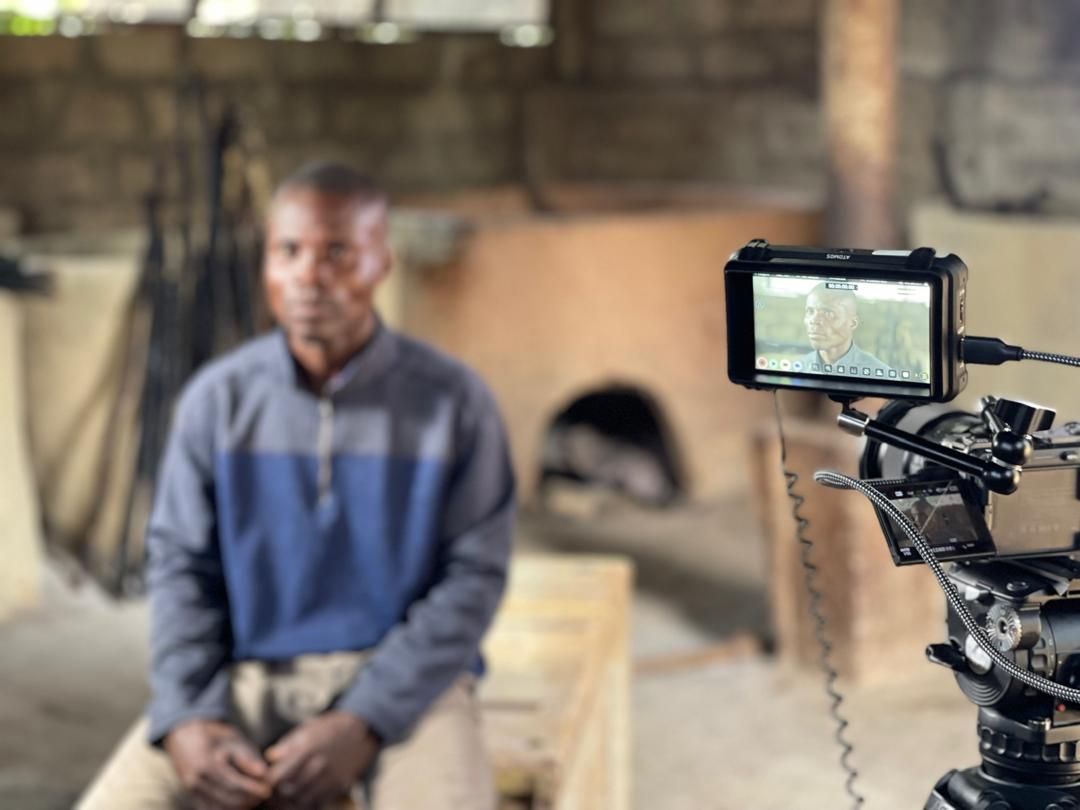 Monitor view of an interview inside the fish-smoking shed in Dixcove